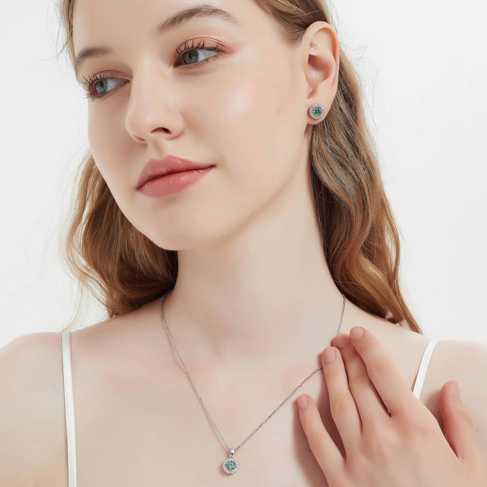 Model wearing Halo Kaleidoscope CZ Stud Earrings in Sterling Silver, Green