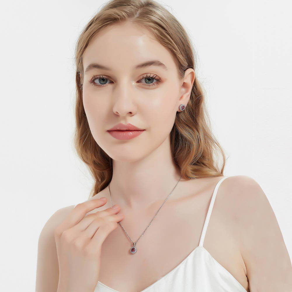 Model wearing Halo Kaleidoscope CZ Stud Earrings in Sterling Silver, Red