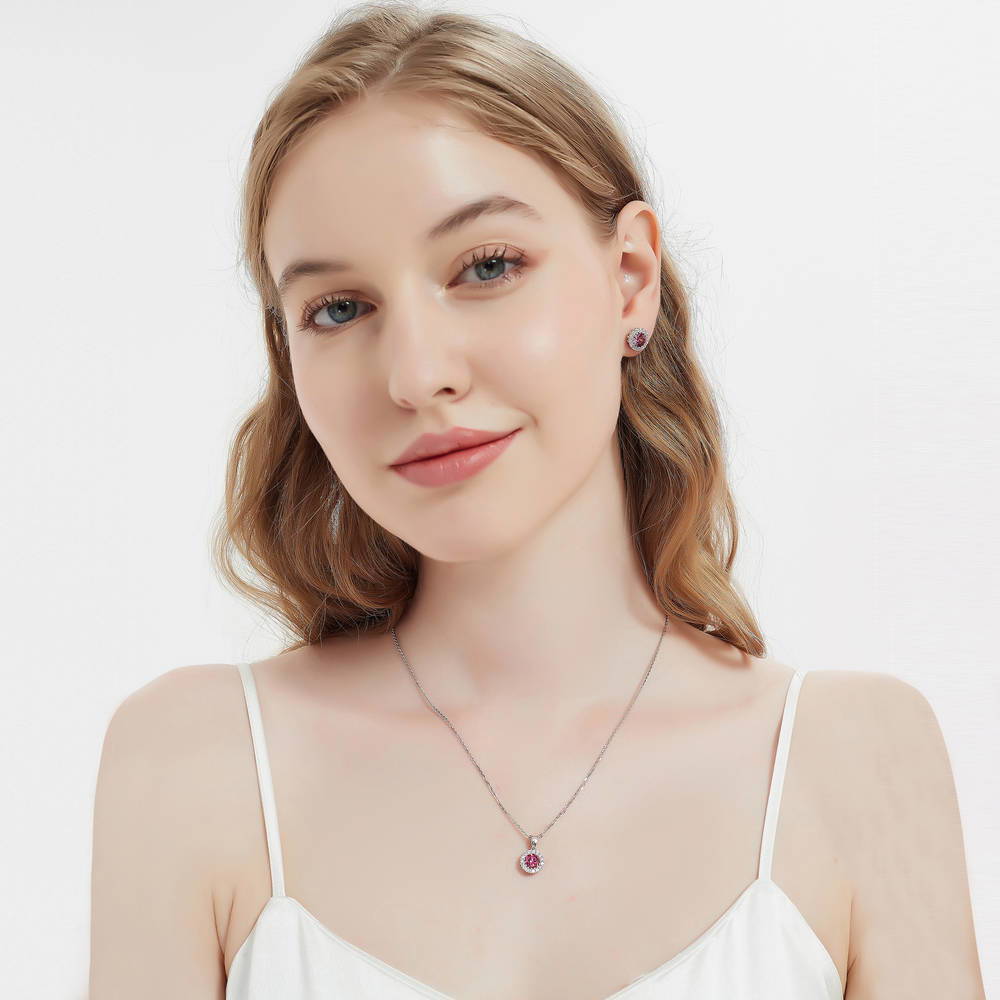 Model wearing Halo Kaleidoscope CZ Stud Earrings in Sterling Silver, Red