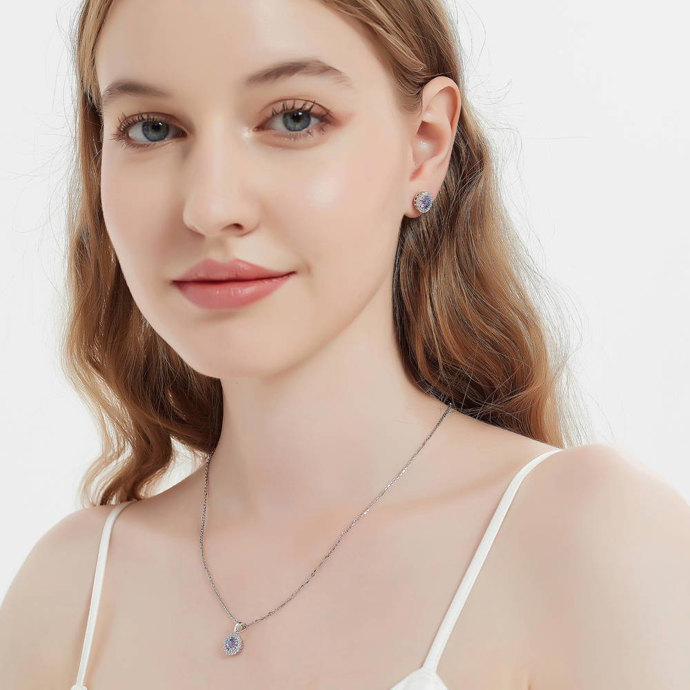 Model wearing Halo Kaleidoscope CZ Stud Earrings in Sterling Silver, Purple Aqua