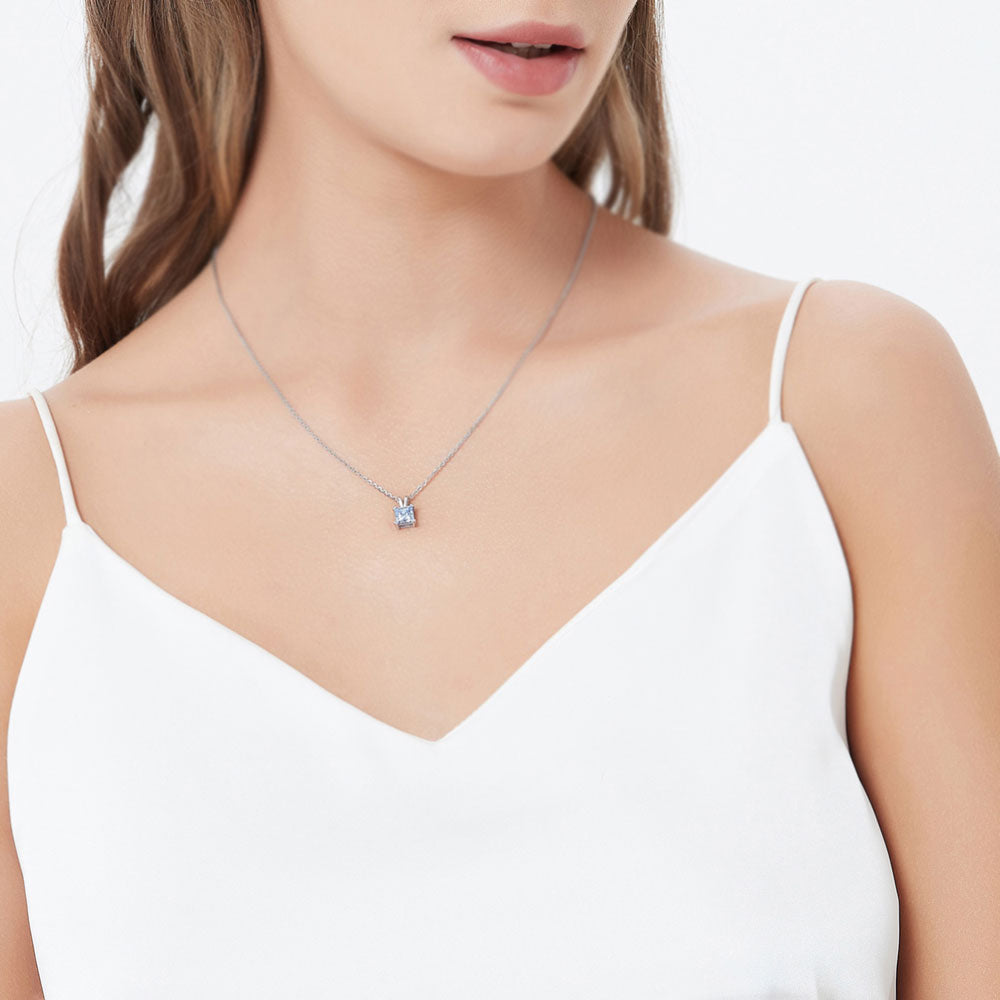 Model wearing Solitaire CZ Necklace in Sterling Silver, Princess Cut / Clear