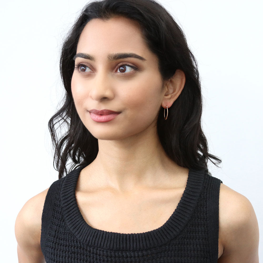 Model wearing Cable Small Hoop Earrings in Sterling Silver 0.9 inch, Yellow Gold Flashed