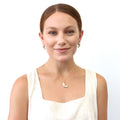 Model wearing Feather CZ Pendant Necklace in Sterling Silver, Yellow Gold Flashed