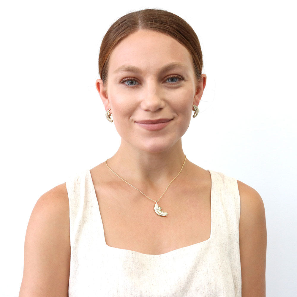 Model wearing Feather CZ Pendant Necklace in Sterling Silver, Yellow Gold Flashed
