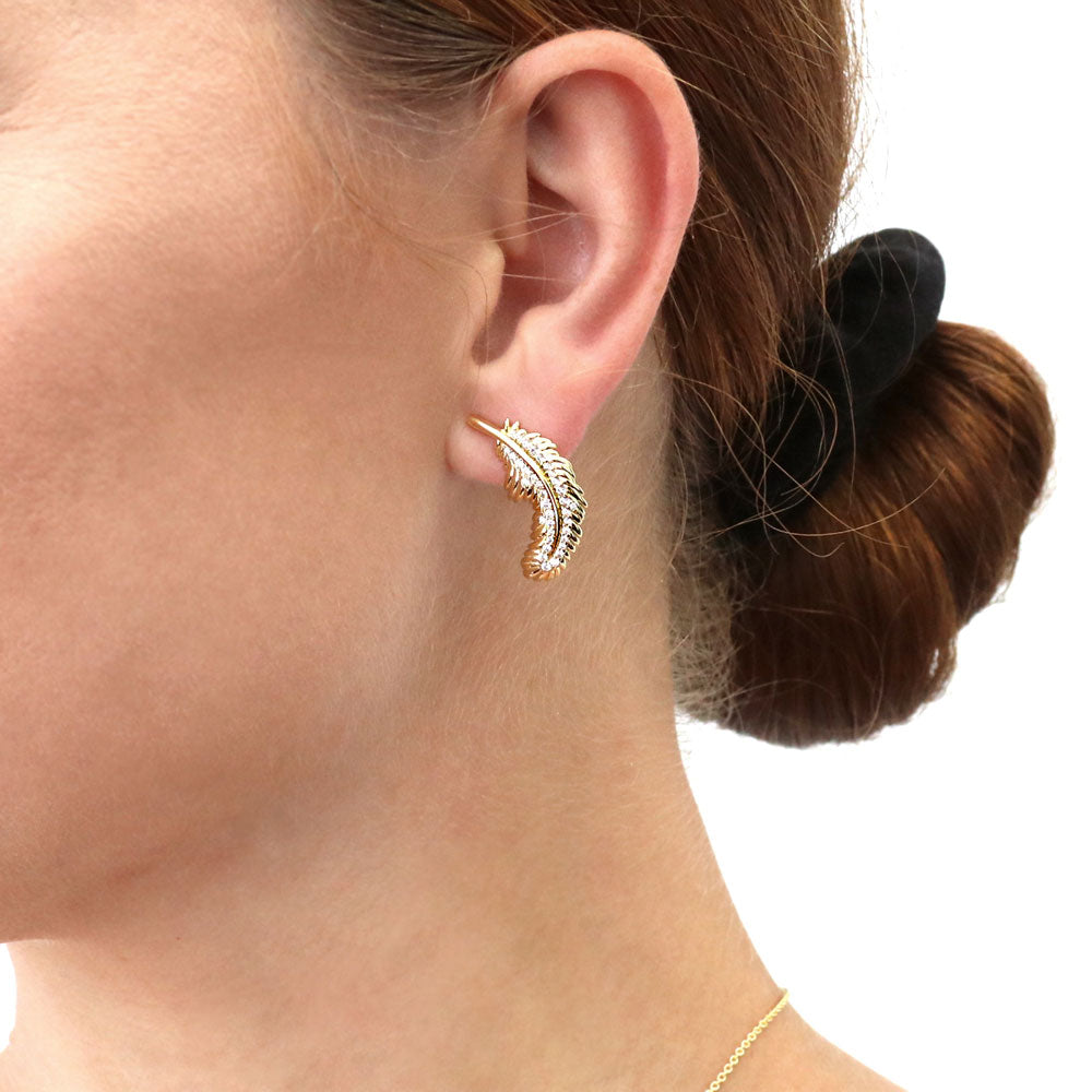Model wearing Feather CZ Stud Earrings in Sterling Silver, Yellow Gold Flashed