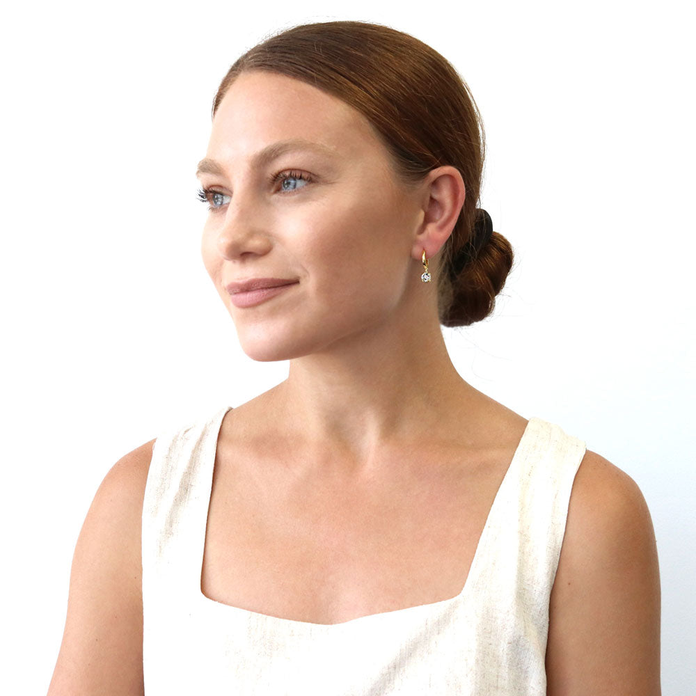 Model wearing Solitaire CZ Cartilage Huggie Earrings in Sterling Silver 0.5 inch, Round Cut, Gold Flashed