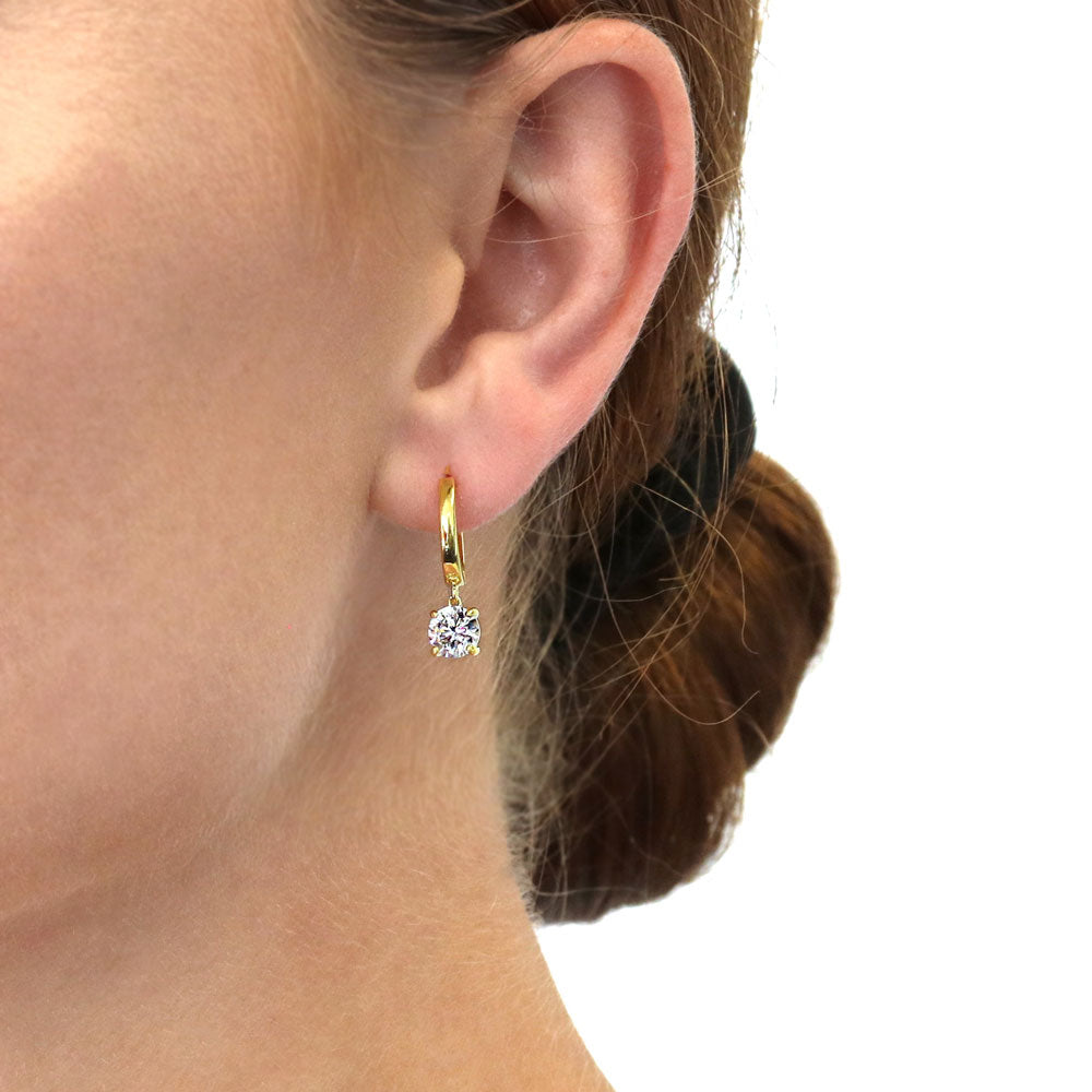Model wearing Solitaire CZ Cartilage Huggie Earrings in Sterling Silver 0.5 inch, Round Cut, Gold Flashed