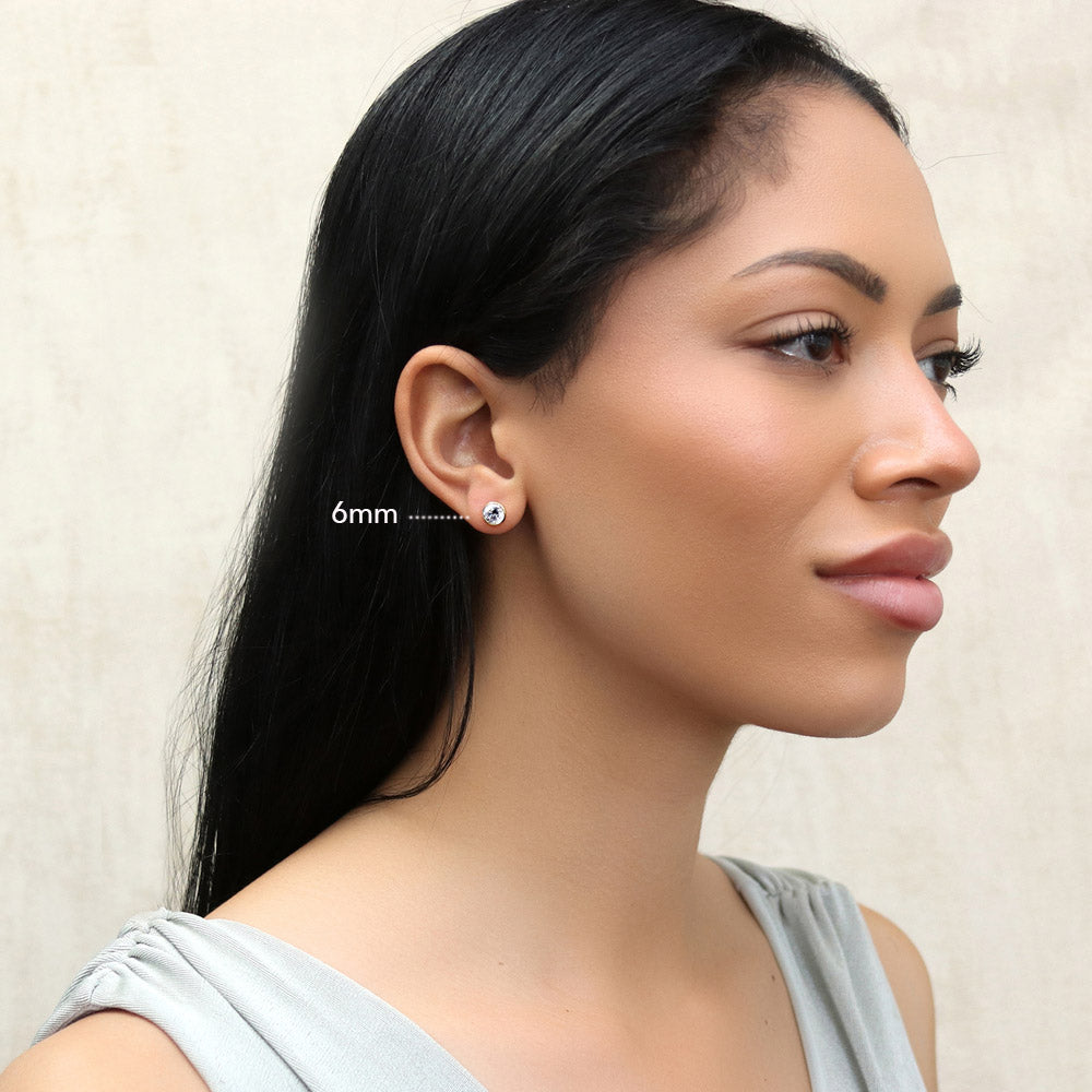 Model wearing Solitaire Bezel CZ Stud Earrings in Gold Flashed Sterling Silver, 4mm