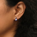 Model wearing Solitaire 2-Stone 1.4ct Pear CZ Stud Earrings in Sterling Silver, Garnet Color