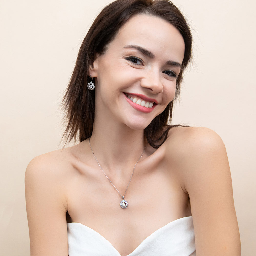 Model wearing Flower Ribbon CZ Necklace and Earrings Set in Sterling Silver