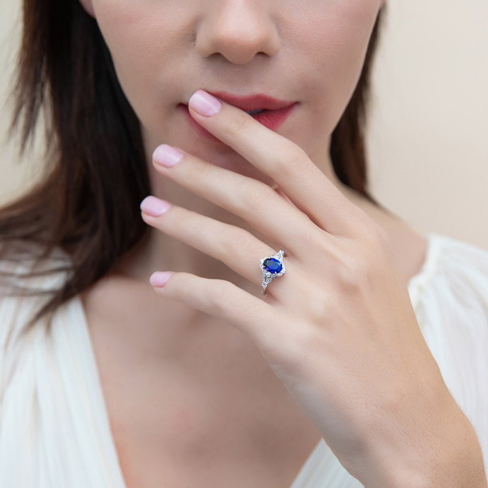 Model wearing Halo Art Deco Simulated Blue Sapphire Oval CZ Ring in Sterling Silver, 6 of 10