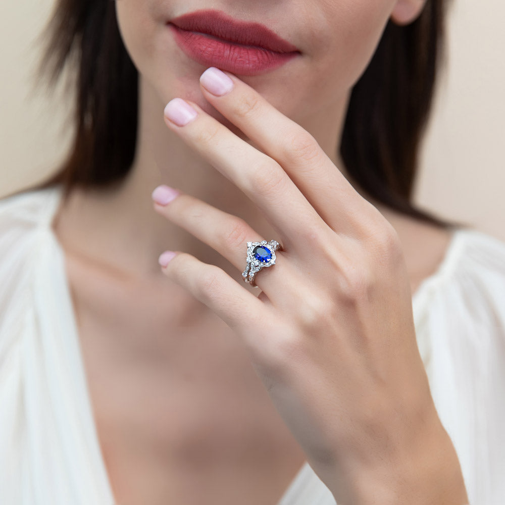 Model wearing Chevron Halo Simulated Blue Sapphire CZ Ring Set in Sterling Silver, 3 of 17
