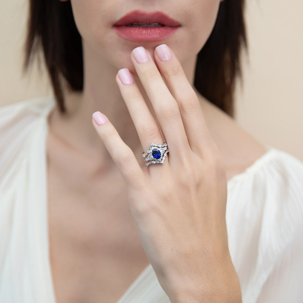 Model wearing Halo Simulated Blue Sapphire Oval CZ Ring Set in Sterling Silver, 6 of 18