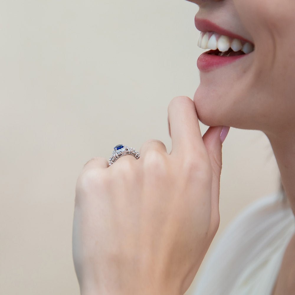 Model wearing Halo Simulated Blue Sapphire Oval CZ Ring Set in Sterling Silver, 7 of 18