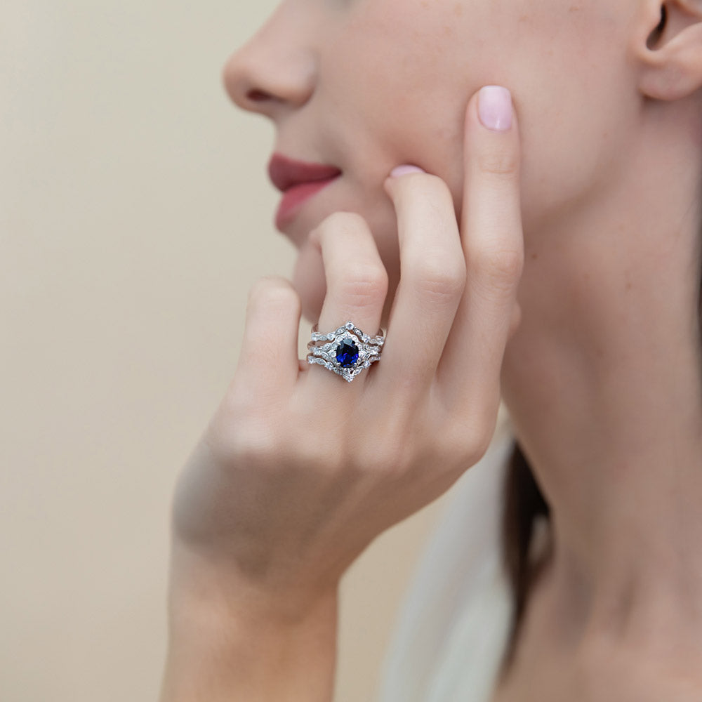 Model wearing Halo Simulated Blue Sapphire Oval CZ Ring Set in Sterling Silver, 2 of 18