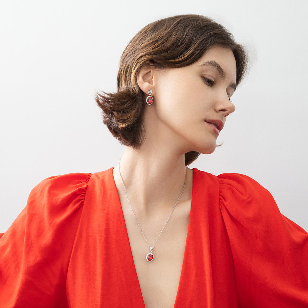 Model wearing Halo Clover Oval CZ Earrings in Sterling Silver, Red Color