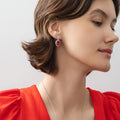 Model wearing Halo Clover Oval CZ Earrings in Sterling Silver, Red Color