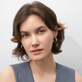 Model wearing Dome Small Hoop Earrings in Sterling Silver 0.8-1 inch, 2 Pairs, Yellow Gold Flashed
