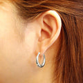 Model wearing Oval Small Hoop Earrings 0.9 inch, Gold-Tone
