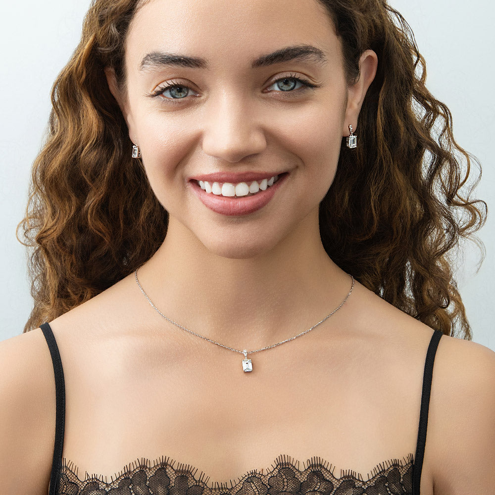 Model wearing Solitaire 1.7ct Emerald Cut CZ Necklace in Sterling Silver, 2 of 7