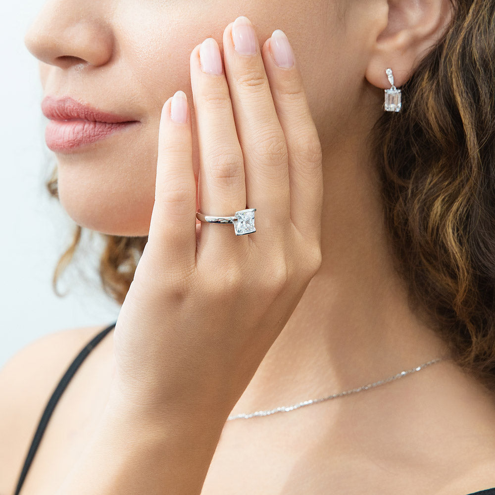Model wearing Solitaire 2ct Bezel Princess CZ Ring in Sterling Silver, 6 of 9