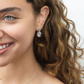Model wearing Halo Clover Oval CZ Earrings in Sterling Silver, Red Color