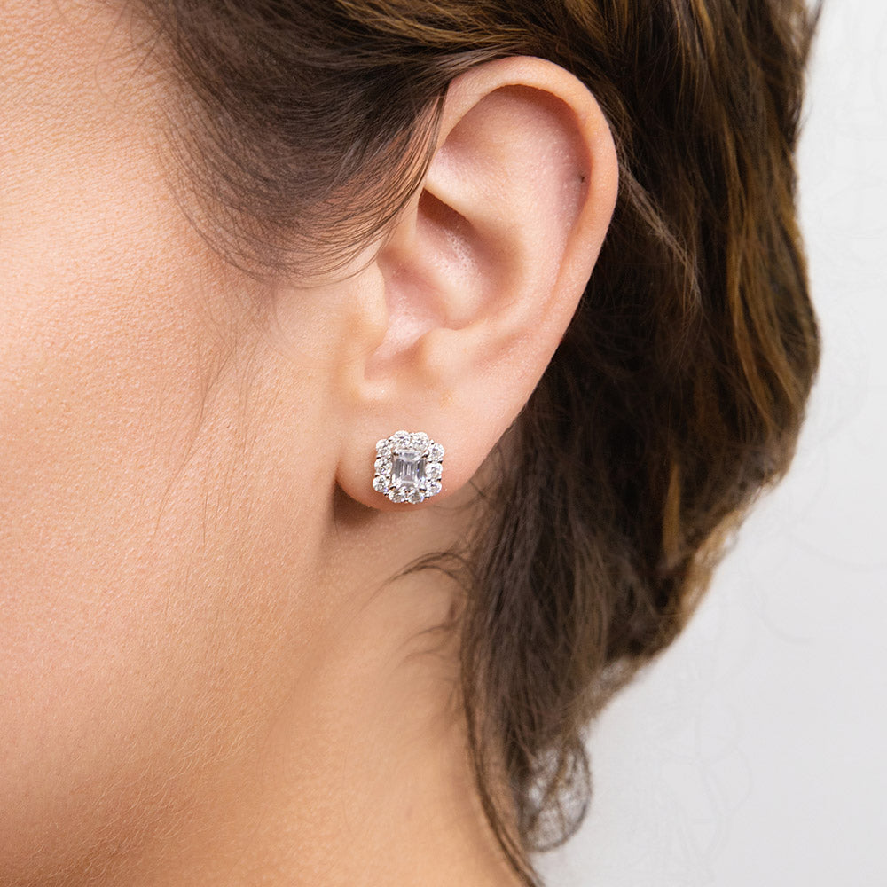 Model wearing Halo Emerald Cut CZ Stud Earrings in Sterling Silver, 5 of 7