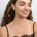 Model wearing Bow Tie Ribbon CZ Necklace in Sterling Silver, Style 1