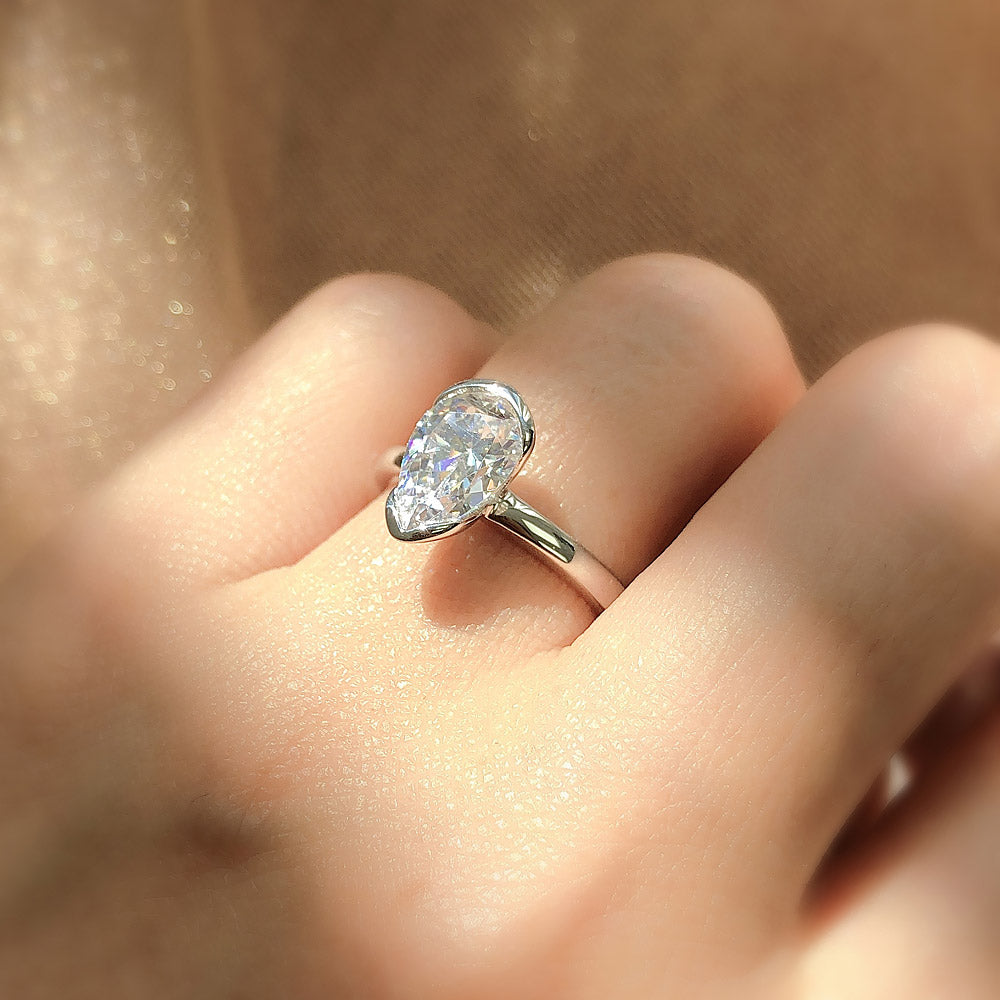 Model wearing Solitaire 1.8ct Bezel Pear CZ Ring in Sterling Silver, 3 of 11