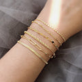 Model wearing Figaro Chain Bracelet in Sterling Silver, Yellow Gold Flashed