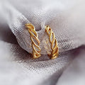 Flatlay view of Woven Small Hoop Earrings in Sterling Silver 0.7 inch, Yellow Gold Flashed