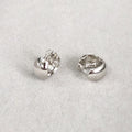 Flatlay view of Dome Mini Huggie Earrings in Sterling Silver 0.5 inch, Rhodium Plated