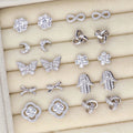 Flatlay view of Flower CZ Stud Earrings in Sterling Silver, Rhodium Plated