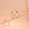 Flatlay view of Woven CZ Small Hoop Earrings in Sterling Silver 0.8 inch, Yellow Gold Flashed