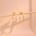Flatlay view of Woven CZ Small Hoop Earrings in Sterling Silver 0.8 inch, Yellow Gold Flashed