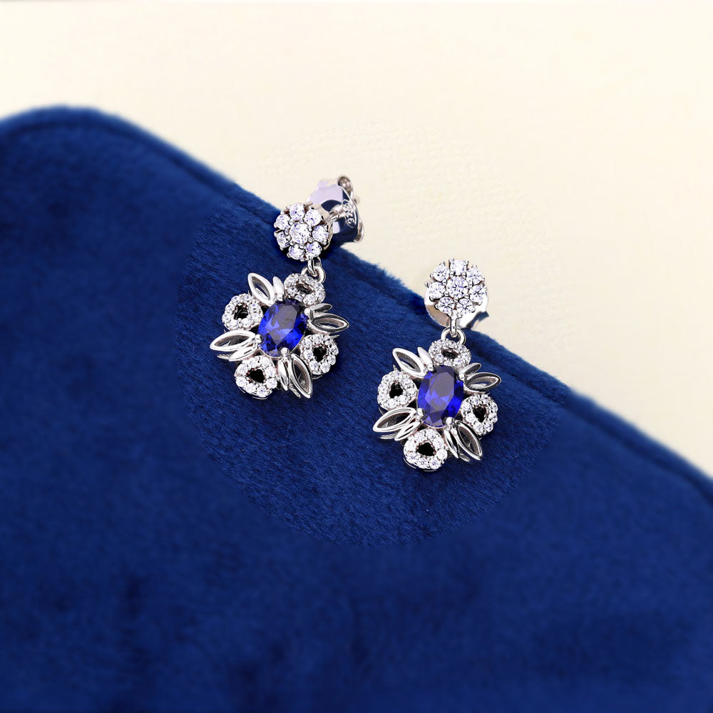 Flatlay view of Flower Halo Sapphire-Blue CZ Earrings in Sterling Silver, 3 of 7