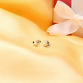Flatlay view of Crescent Moon Cartilage Stud Earrings in Sterling Silver, Yellow Gold Flashed