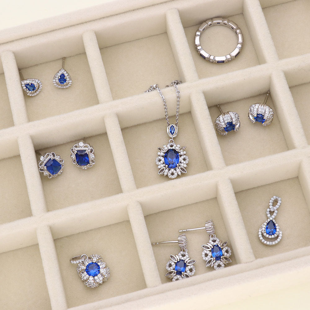 Flatlay view of Flower Halo Sapphire-Blue CZ Earrings in Sterling Silver, 6 of 7