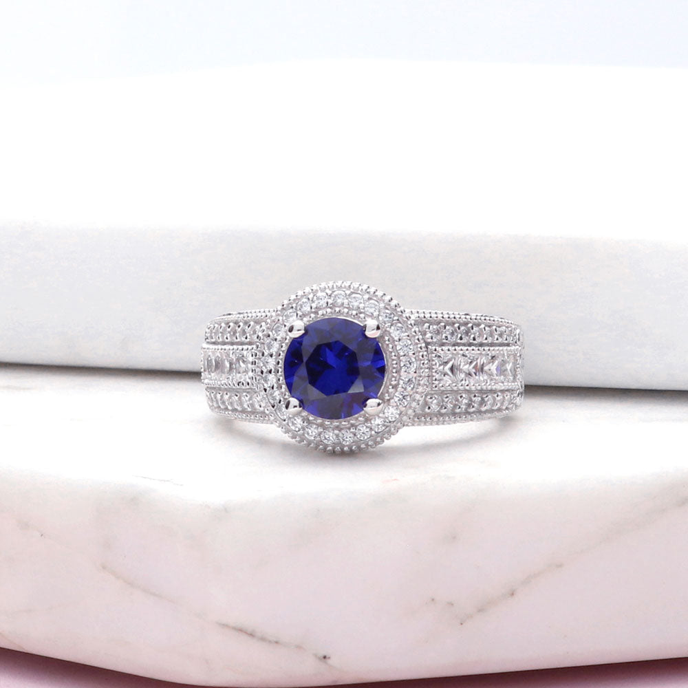 Flatlay view of Halo Milgrain Simulated Blue Sapphire Round CZ Ring in Sterling Silver, 9 of 14