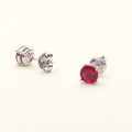 Flatlay view of Solitaire 1.6ct CZ Cartilage Stud Earrings in Sterling Silver, Garnet Color