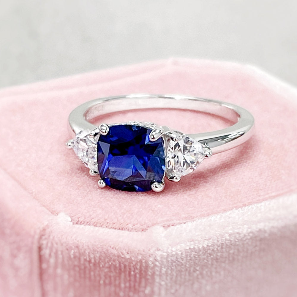 Flatlay view of 3-Stone 3ct Sapphire-Blue Cushion CZ Ring in Sterling Silver, 10 of 12