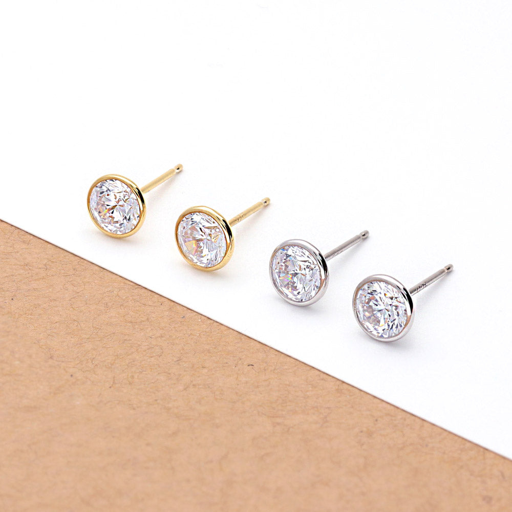 Flatlay view of Solitaire Bezel CZ Stud Earrings in Sterling Silver