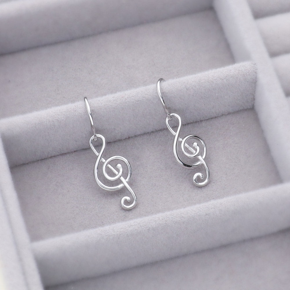 Flatlay view of Treble Clef Music Note Fish Hook Earrings in Sterling Silver, 4 of 8