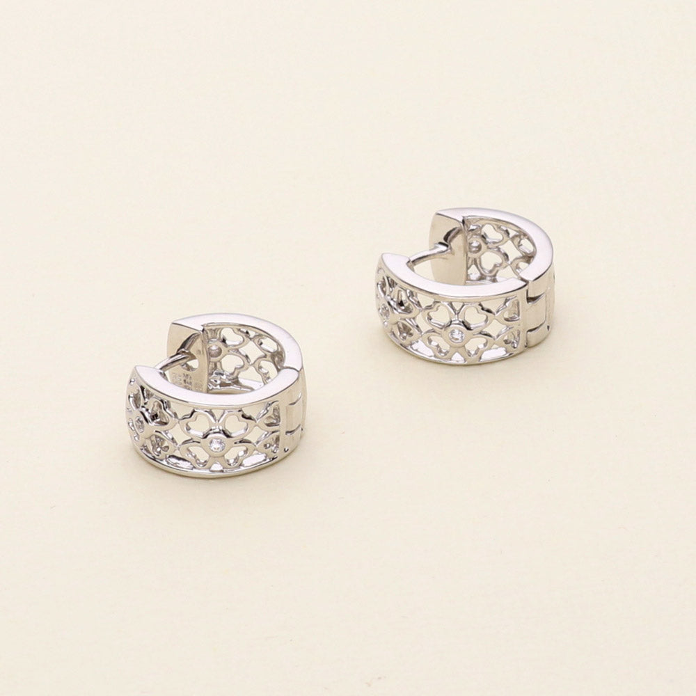 Flatlay view of Clover CZ Small Huggie Earrings in Sterling Silver 0.55 inch, 8 of 11