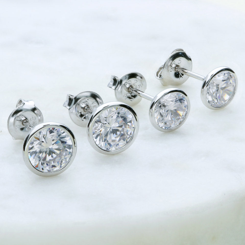 Flatlay view of Solitaire Bezel CZ Stud Earrings in Sterling Silver