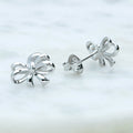 Flatlay view of Bow Tie Ribbon CZ Stud Earrings in Sterling Silver, Style 1