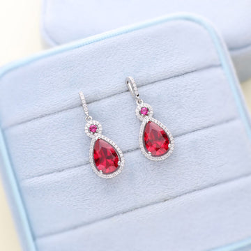 Halo Simulated Ruby Pear CZ Dangle Earrings in Sterling Silver