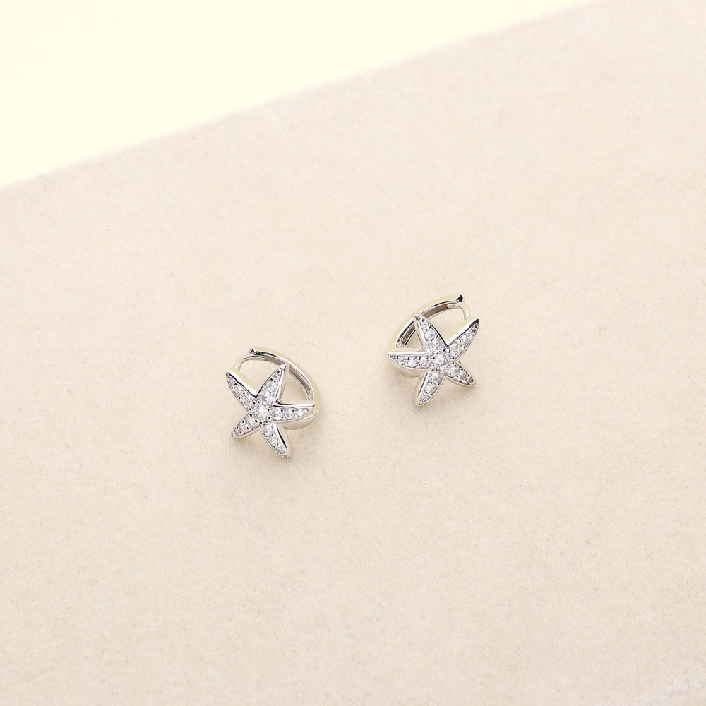 Flatlay view of Starfish CZ Mini Huggie Earrings in Sterling Silver 0.5 inch, 5 of 6