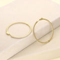 Flatlay view of CZ Large Inside-Out Hoop Earrings in Sterling Silver 2 inch, Yellow Gold Flashed