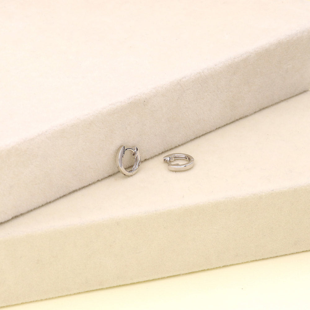 Flatlay view of Mini Huggie Earrings in Sterling Silver 0.45 inch, 4 of 10